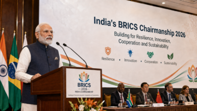India's BRICS Chairmanship 2026 event showing Prime Minister Narendra Modi speaking at a BRICS podium in front of delegates and the four key pillars backdrop