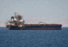 Strait of Hormuz vessel attack showing a commercial ship hit by an unknown projectile