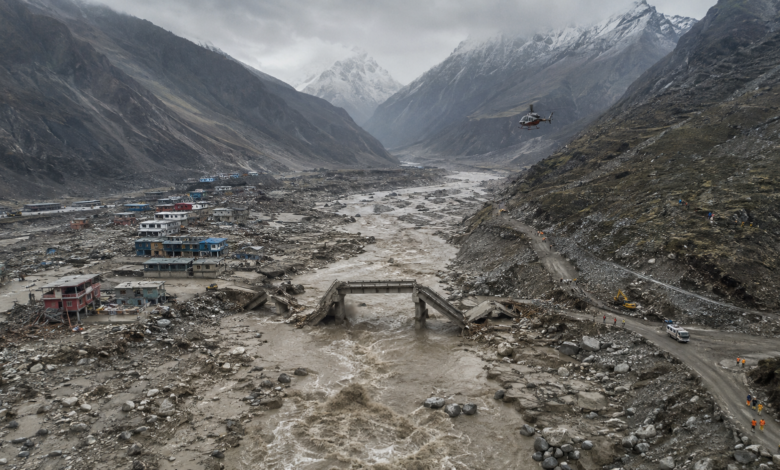 Nepal floods 2026 showing severe destruction in a Himalayan river valley, damaged bridges, debris and rescue operations
