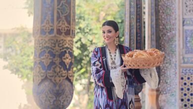 Saodat Tursunova presenting traditional Uzbek bread in an Uzbek cultural setting