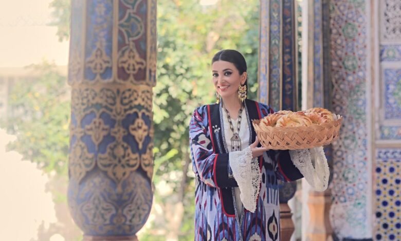 Saodat Tursunova presenting traditional Uzbek bread in an Uzbek cultural setting